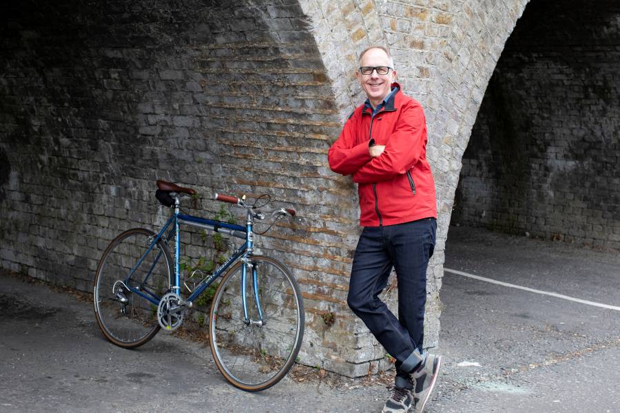 David Bonney Standing Next To A Bike